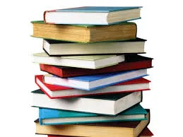 Stack of hardcover books in assorted colors